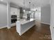 Modern kitchen with stainless steel appliances and a center island with white countertop at 11211 James Coy Rd, Huntersville, NC 28078