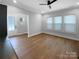 Bright living area with hardwood floors, multiple windows, and neutral walls at 11211 James Coy Rd, Huntersville, NC 28078