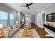 Open-concept living room with modern furniture and hardwood floors; kitchen in background at 11211 James Coy Rd, Huntersville, NC 28078