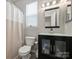Modern bathroom features glass shower door, updated vanity, and sleek fixtures at 11332 Anna Rose Rd, Charlotte, NC 28273