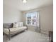 Bright bedroom featuring a daybed, large window, and modern decor at 11332 Anna Rose Rd, Charlotte, NC 28273