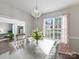 Bright dining room with chandelier, neutral palette and dark hardwood floors at 11332 Anna Rose Rd, Charlotte, NC 28273