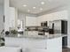 Well-lit kitchen features granite countertops, white cabinets, and stainless steel refrigerator at 11332 Anna Rose Rd, Charlotte, NC 28273