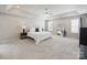 Spacious main bedroom with tray ceiling, ceiling fan, large mirror, and great natural light at 11332 Anna Rose Rd, Charlotte, NC 28273