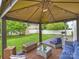 Cozy patio with comfortable seating, outdoor lighting, and a view of the landscaped backyard at 11332 Anna Rose Rd, Charlotte, NC 28273
