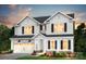 Charming two-story home with white siding, black shutters, a two-car garage, and a beautifully landscaped front yard at 12235 Colton View Ln # 386, Charlotte, NC 28278