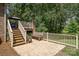 Back patio with a grill, additional seating, and stairs leading to a second story deck at 135 Oak Creek Dr, Rockwell, NC 28138