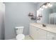 Neutral bathroom featuring a single sink vanity, decorative shelves, and light paint at 135 Oak Creek Dr, Rockwell, NC 28138