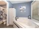 Bathroom featuring soaking tub, tiled surround, and stylish fixtures at 135 Oak Creek Dr, Rockwell, NC 28138