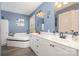 Bathroom with double vanity, soaking tub, and elegant fixtures at 135 Oak Creek Dr, Rockwell, NC 28138
