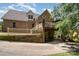 Exterior view of a brick house featuring a back deck, patio, and a two car garage at 135 Oak Creek Dr, Rockwell, NC 28138
