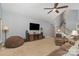 Spacious living room featuring a ceiling fan, neutral colors, access to the staircase, and comfortable seating at 135 Oak Creek Dr, Rockwell, NC 28138