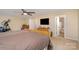 Spacious main bedroom featuring a ceiling fan, TV, and en-suite bathroom at 135 Oak Creek Dr, Rockwell, NC 28138