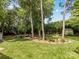 Large backyard with manicured lawn, trees and a garden shed at 13600 Seastone Ln, Pineville, NC 28134