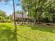 Expansive backyard with green lawn, landscaping, and rear exterior view of house at 13600 Seastone Ln, Pineville, NC 28134