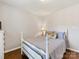 Neutral bedroom featuring a white bed frame, hardwood floors, and a lamp at 13600 Seastone Ln, Pineville, NC 28134