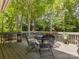 Outdoor deck area featuring metal patio set and flower pot arrangements at 13600 Seastone Ln, Pineville, NC 28134