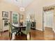 Light filled dining room with hardwood floors, decorative mirror and chandelier at 13600 Seastone Ln, Pineville, NC 28134