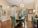 This stylish dining room features hardwood floors, wainscoting, and a modern chandelier at 13600 Seastone Ln, Pineville, NC 28134