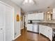Bright kitchen with a breakfast bar, white cabinetry and stainless steel appliances at 13600 Seastone Ln, Pineville, NC 28134