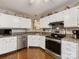 Well-lit kitchen with white cabinets, granite countertops, and stainless steel appliances at 13600 Seastone Ln, Pineville, NC 28134
