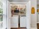 Laundry room features a stacked washer and dryer, shelving, and extra storage space at 13600 Seastone Ln, Pineville, NC 28134