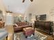 Spacious living room with a leather sofa, ottoman, and modern entertainment center at 13600 Seastone Ln, Pineville, NC 28134