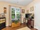 Inviting living room featuring hardwood floors, a bright window, and a dark wooden dresser at 13600 Seastone Ln, Pineville, NC 28134