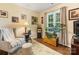 Cozy living room with a comfortable chair, area rug, and bright natural light at 13600 Seastone Ln, Pineville, NC 28134