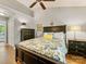 Well-lit main bedroom with a ceiling fan, hardwood floors, and modern furniture at 13600 Seastone Ln, Pineville, NC 28134