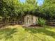 Outdoor storage shed with double doors in landscaped backyard at 13600 Seastone Ln, Pineville, NC 28134
