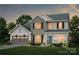 Charming two-story home showcases stone accents, a two-car garage, and manicured landscaping, offering a welcoming curb appeal at 13932 Penbury Rd # 400, Charlotte, NC 28278