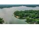 Picturesque aerial view of a lakefront property surrounded by trees and scenic views at 18205 Royal Oak Rd, Charlotte, NC 28278
