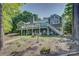 Expansive backyard with a multi-level deck, lush lawn, and mature trees provides a private oasis at 18205 Royal Oak Rd, Charlotte, NC 28278