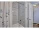 Modern bathroom featuring a tiled shower with a rainfall showerhead and sleek design, combining luxury with functionality at 18205 Royal Oak Rd, Charlotte, NC 28278