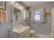 Stylish bathroom with a white vanity, decorative mirror, and modern fixtures, offering a clean and updated space at 18205 Royal Oak Rd, Charlotte, NC 28278