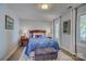 Serene bedroom with a blue patterned comforter, natural light, and tranquil decor, perfect for relaxation and rest at 18205 Royal Oak Rd, Charlotte, NC 28278