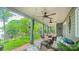 Inviting covered patio with comfortable seating, ceiling fans and views of a lush backyard at 18205 Royal Oak Rd, Charlotte, NC 28278