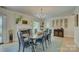 Elegant dining room with a fireplace, chandelier, and stylish decor for sophisticated gatherings at 18205 Royal Oak Rd, Charlotte, NC 28278