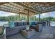 Dock interior has plenty of space for lounging on a comfortable outdoor sectional with pillows and a coffee table at 18205 Royal Oak Rd, Charlotte, NC 28278
