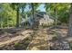 Beautiful exterior of a well-maintained house surrounded by mature trees and a charming mulch path at 18205 Royal Oak Rd, Charlotte, NC 28278
