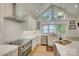Bright, modern kitchen with white cabinets, stainless steel appliances, and a view of the lake at 18205 Royal Oak Rd, Charlotte, NC 28278