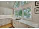 Bright and modern kitchen featuring white cabinetry, stainless steel appliances, and a picturesque lake view at 18205 Royal Oak Rd, Charlotte, NC 28278