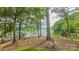 Breathtaking lake view from a beautifully landscaped yard with mature trees at 18205 Royal Oak Rd, Charlotte, NC 28278