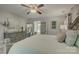 Comfortable main bedroom with light gray furniture, decorative ceiling fan, and bright ambiance at 18205 Royal Oak Rd, Charlotte, NC 28278