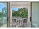Secluded outdoor balcony featuring a table and seating, overlooking lush greenery at 19329 Watermark Dr # 422, Cornelius, NC 28031