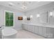 Elegant bathroom features a modern chandelier, double vanities, and a free-standing tub at 19329 Watermark Dr # 422, Cornelius, NC 28031