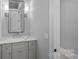 Clean bathroom with a modern vanity, marble countertop, and a framed mirror at 19329 Watermark Dr # 422, Cornelius, NC 28031