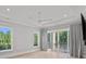 Bright, spacious bedroom featuring large windows, tray ceiling, and balcony access at 19329 Watermark Dr # 422, Cornelius, NC 28031