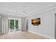 Spacious, modern bedroom featuring an outside balcony and large screen television at 19329 Watermark Dr # 422, Cornelius, NC 28031